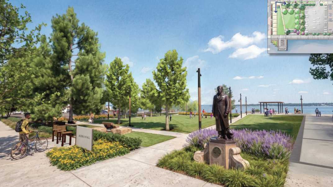 Waterfront park with a bronze statue, green trees, purple flowers, benches, and people strolling by the lake; inset map shown in the top-right corner.